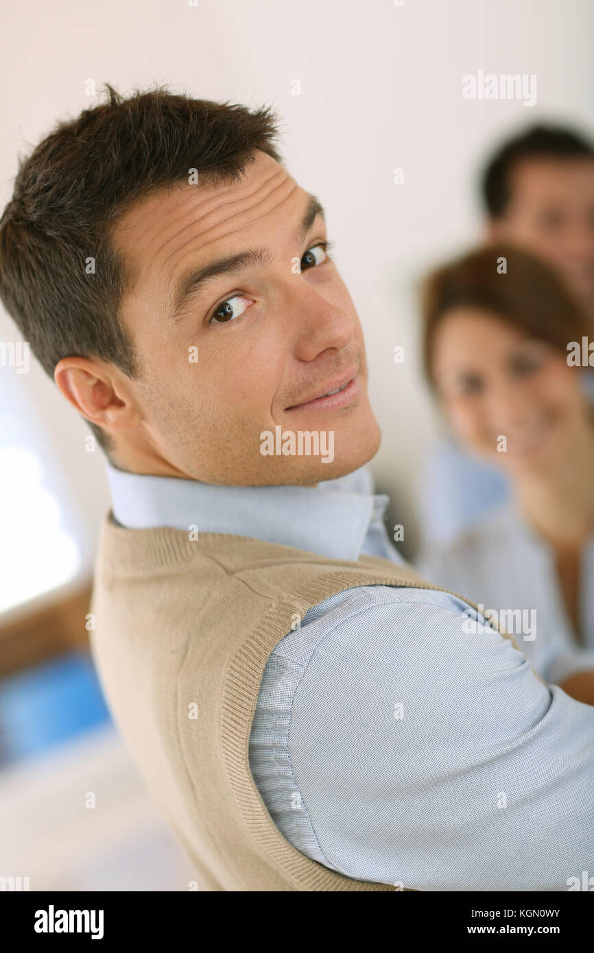 Handsome man standing in front of business team Stock Photo - Alamy