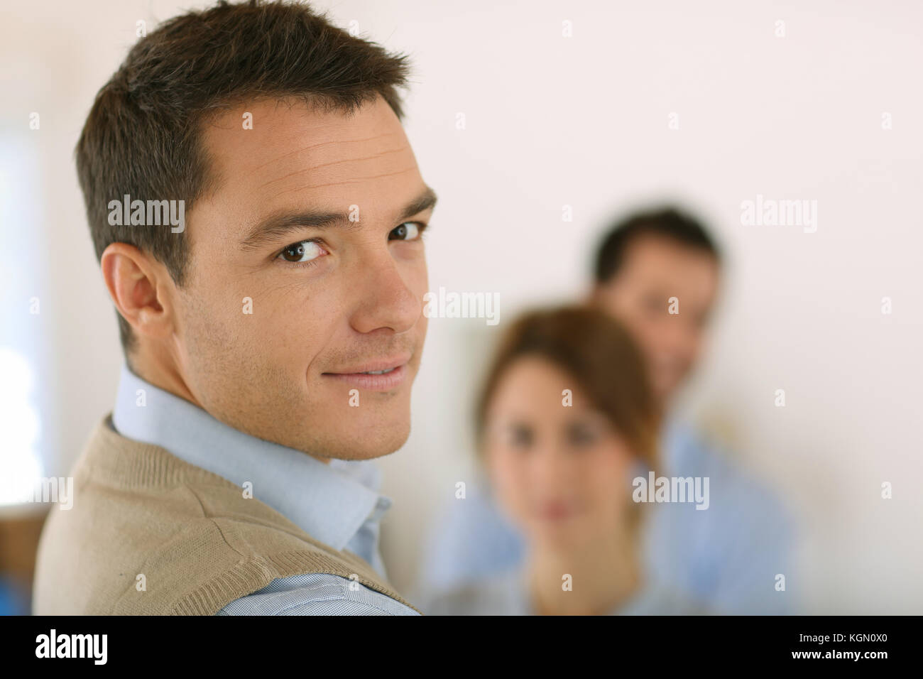 Handsome man standing in front of business team Stock Photo - Alamy