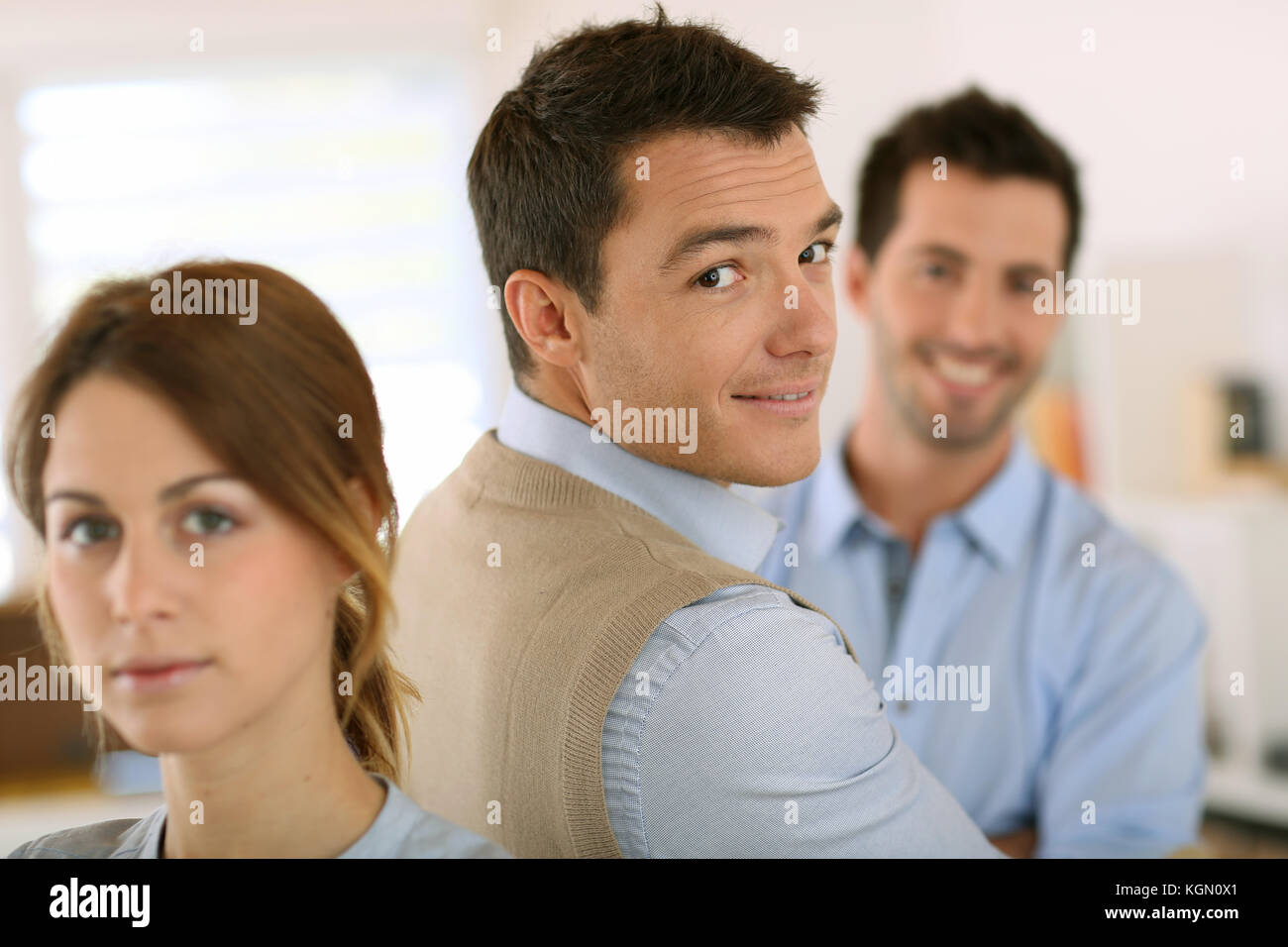 Handsome man standing in front of business team Stock Photo - Alamy