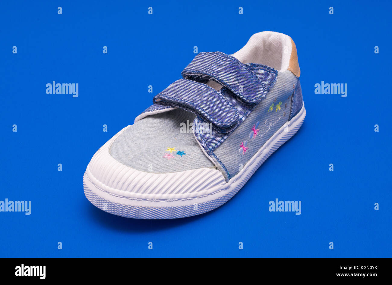 Pair of fashion denim baby shoes for the toddlers feet. Kids sneakers