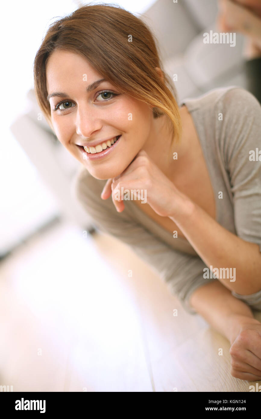 Smiling girl relaxing on the floor at home Stock Photo - Alamy