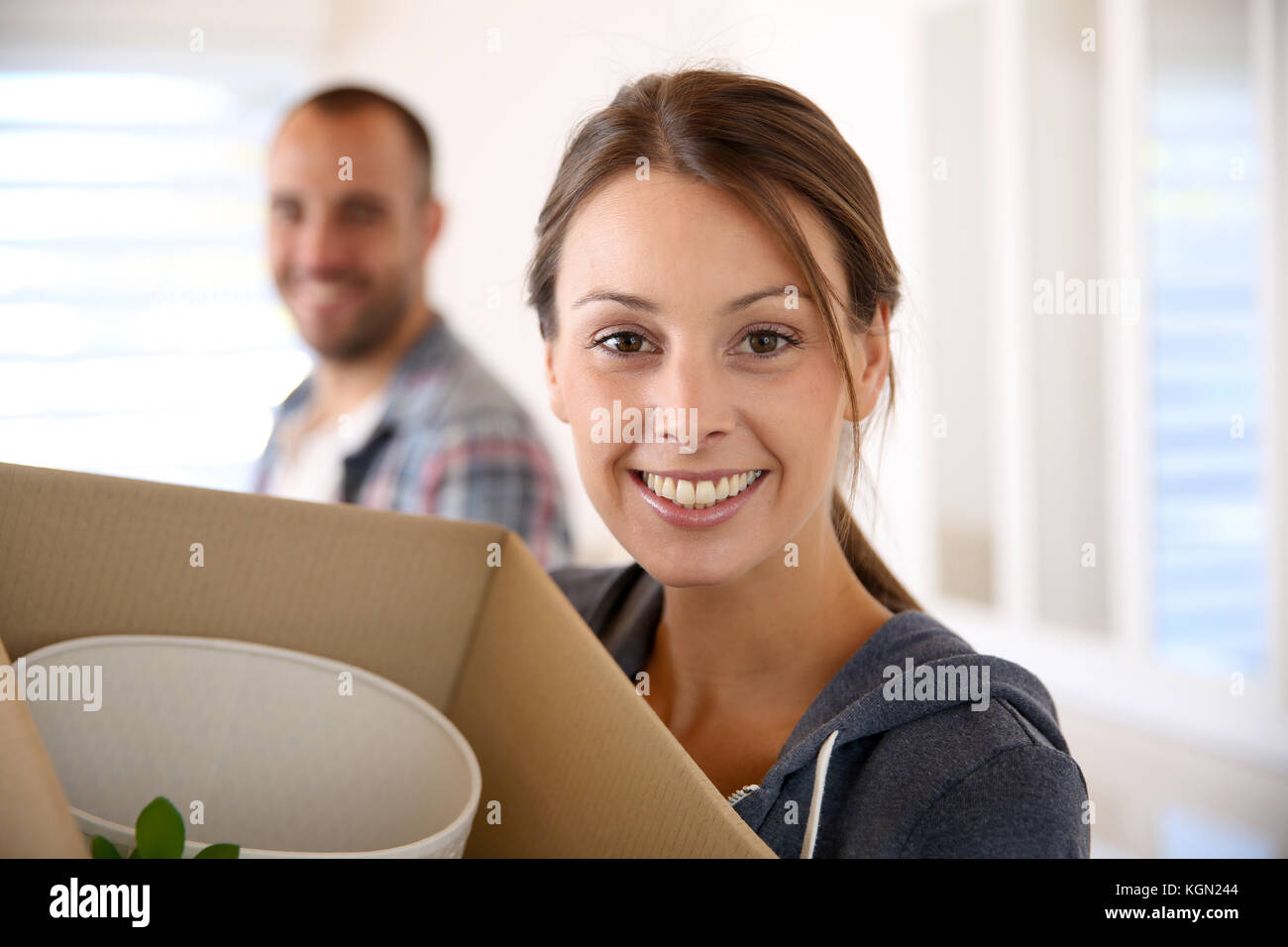 Cheerful young adults packing their stuff in cardboards Stock Photo - Alamy