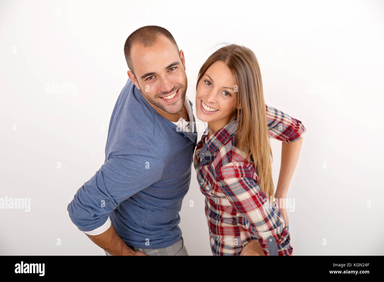 Smiling couple standing on white background Stock Photo - Alamy