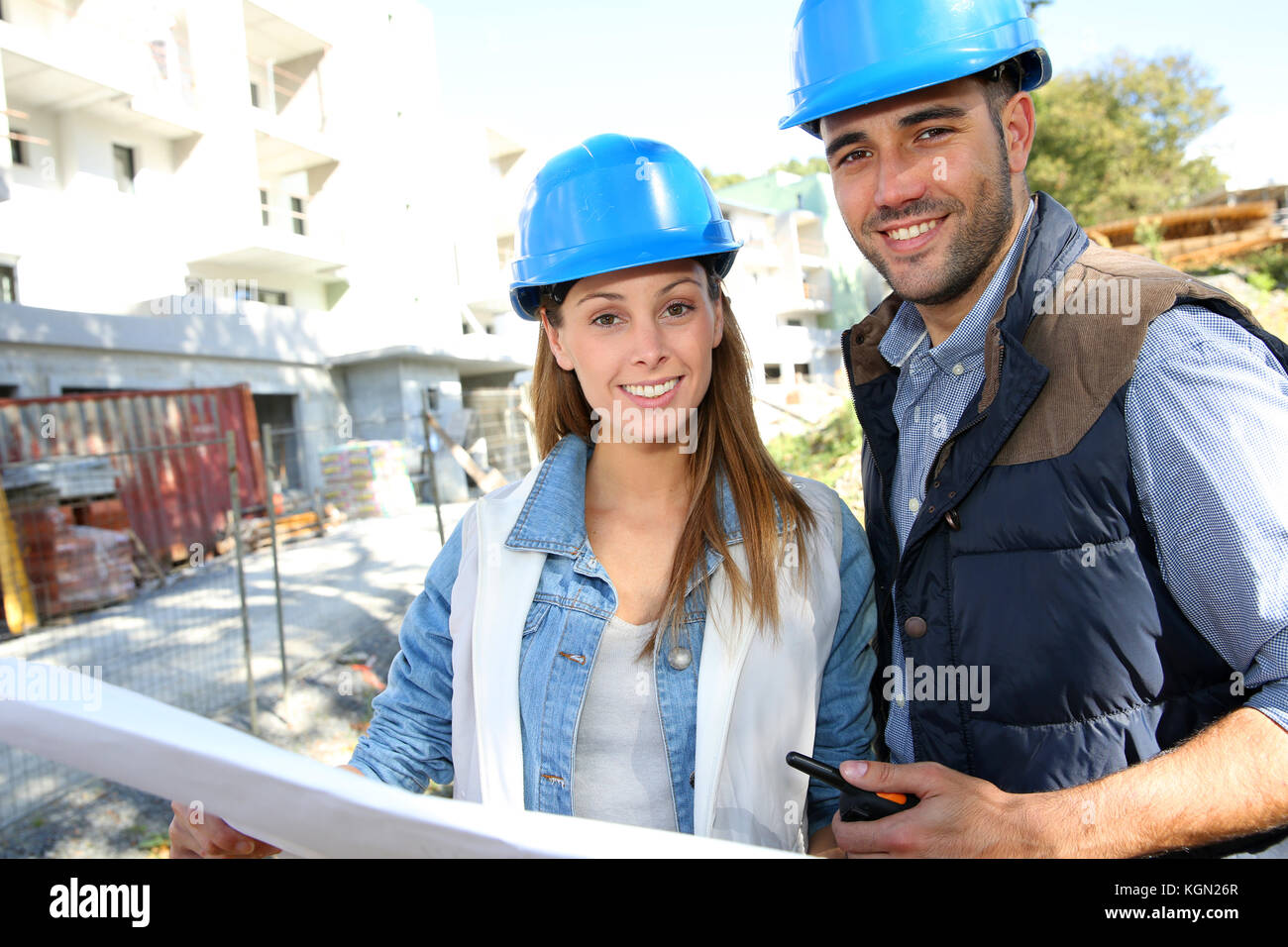 Smiling architects standing on construction site Stock Photo - Alamy