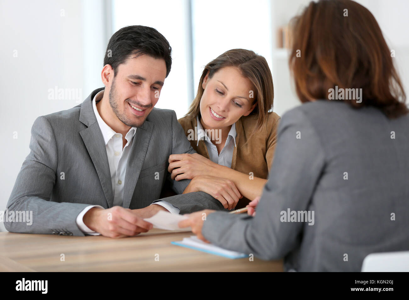 Couple meeting financial adviser for construction project Stock Photo