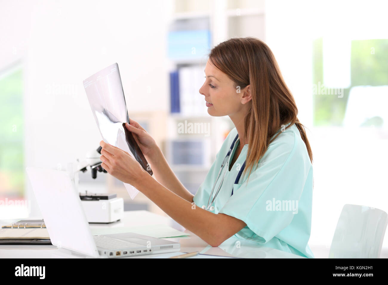 Nurse reading XRay results in hospital office Stock Photo Alamy