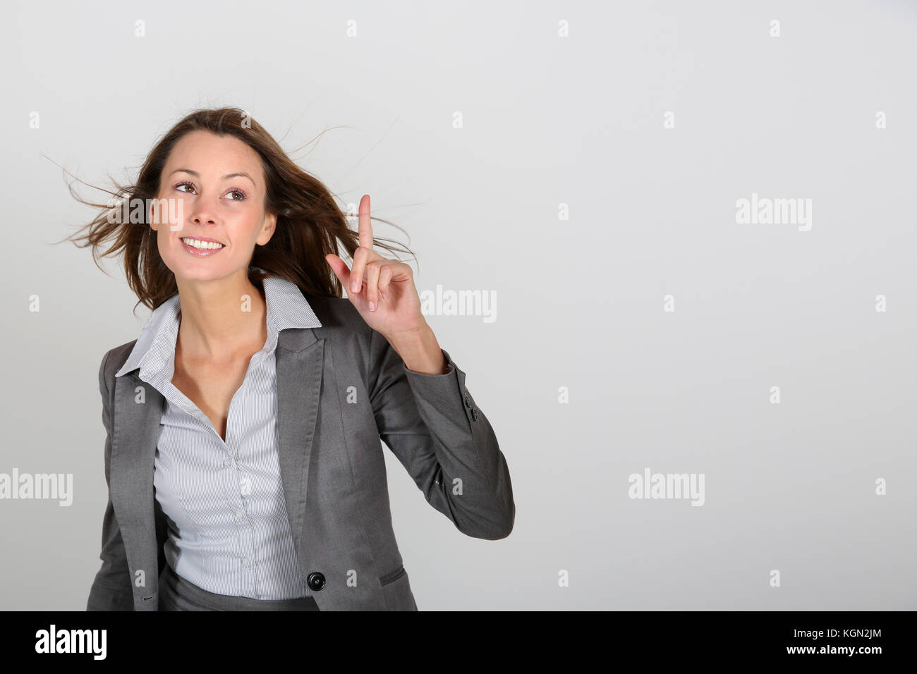 Grey suit woman pointing hi-res stock photography and images - Alamy