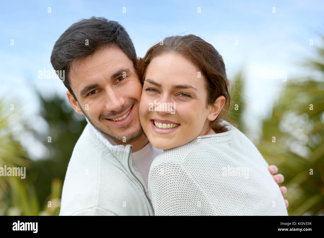 Couple embracing each other in front of house Stock Photo