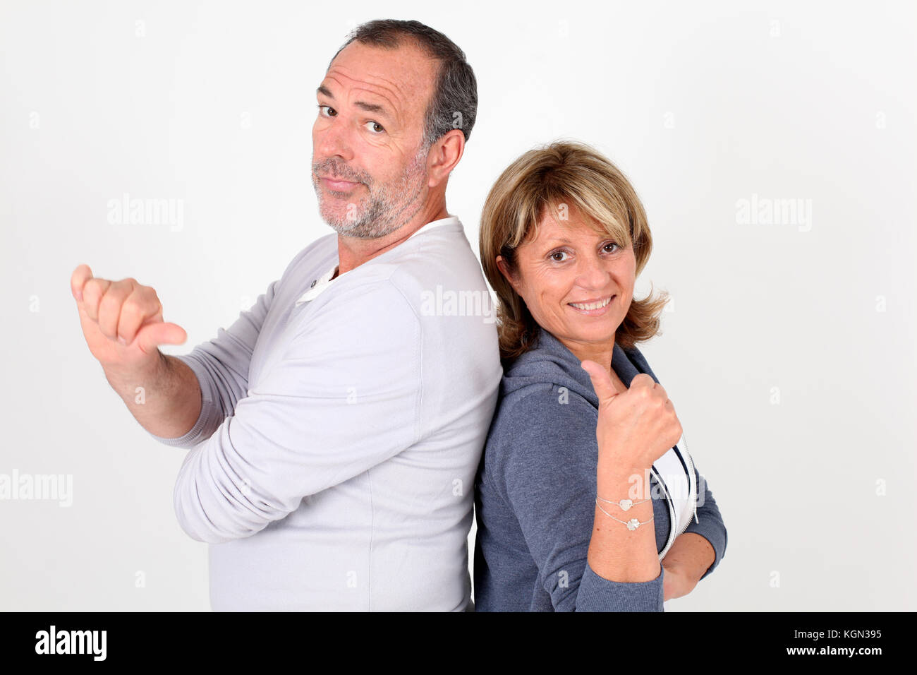 Senior couple with thumbs up and down Stock Photo - Alamy