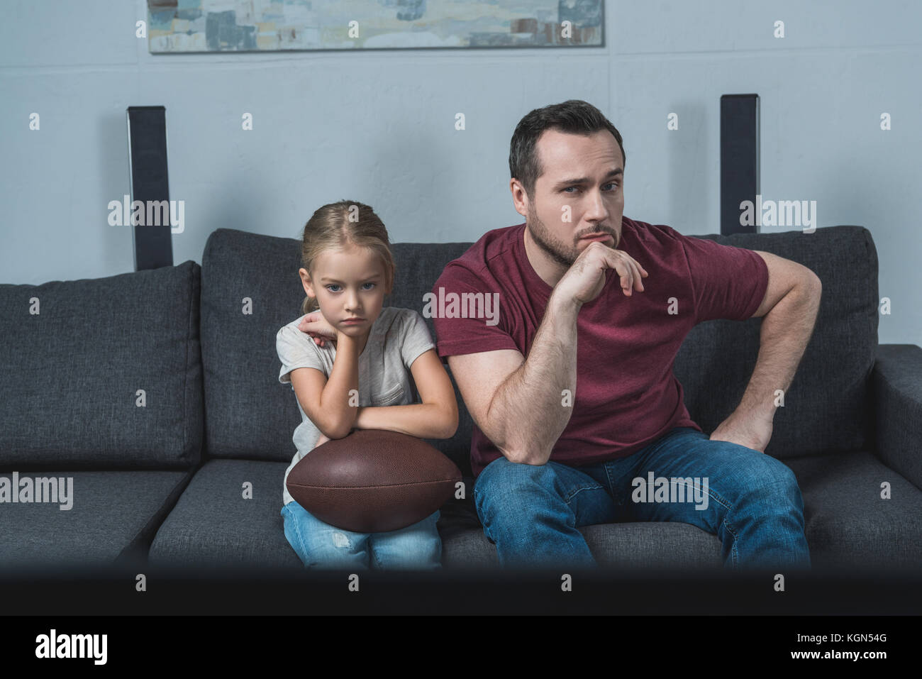 Father and daughter watching american football game Stock Photo Alamy