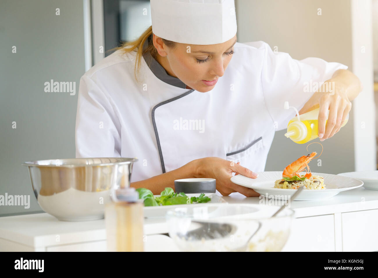 Chef preparing dish in professional kitchen Stock Photo Alamy