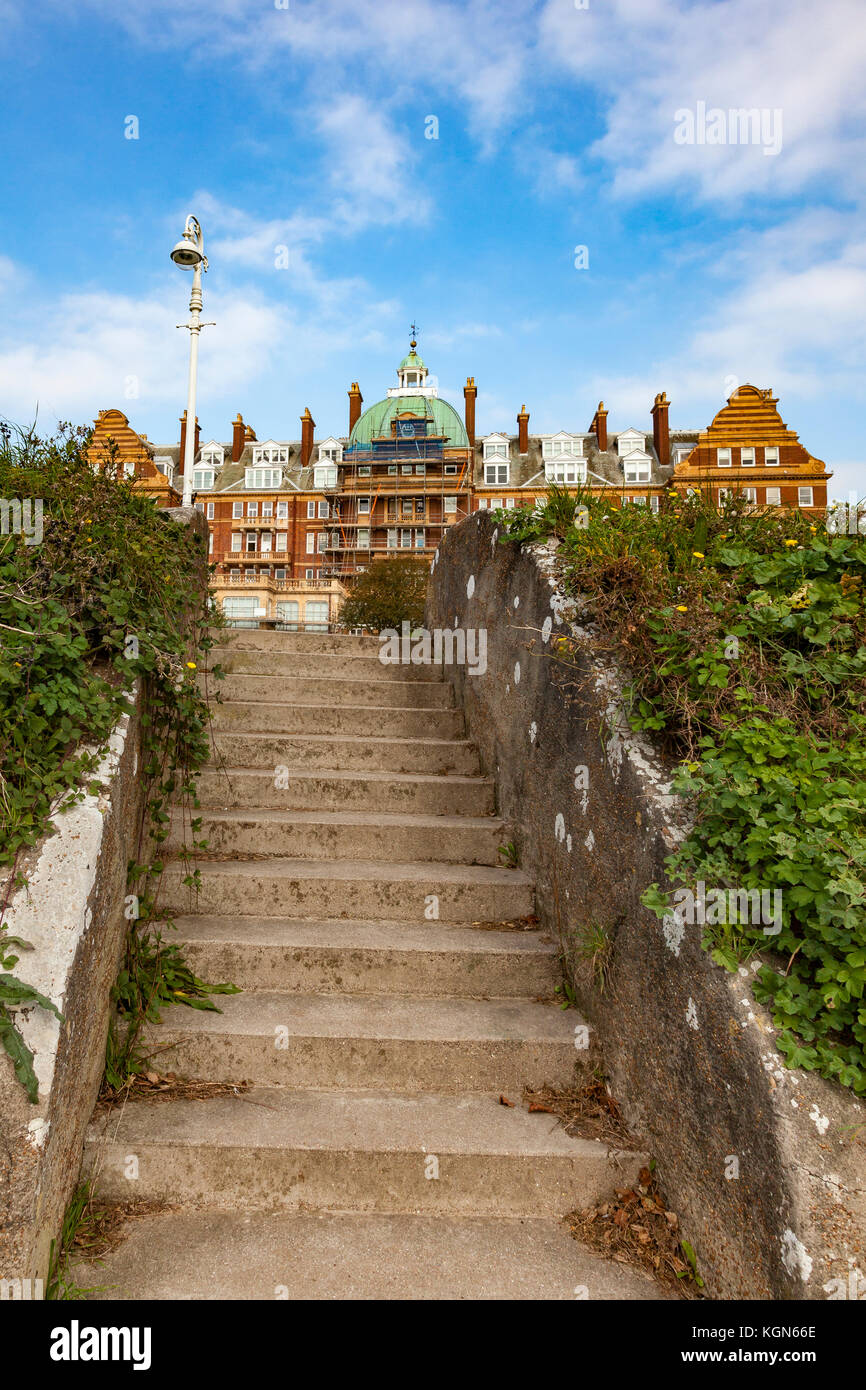 Steps up from a cliff walk path to The Leas with the Metropole building