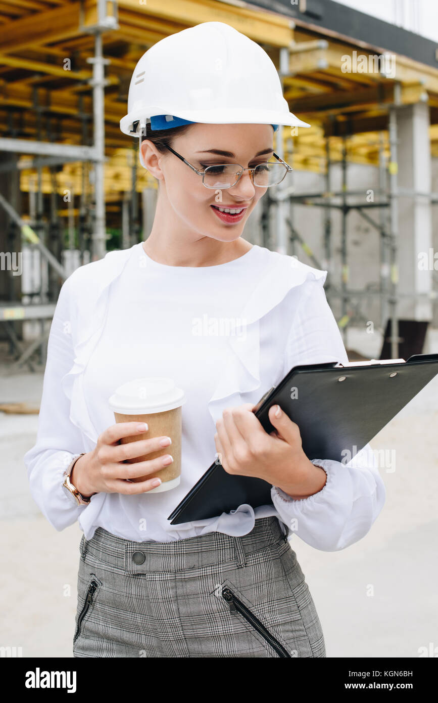 engineer at construction holding clipboard Stock Photo Alamy