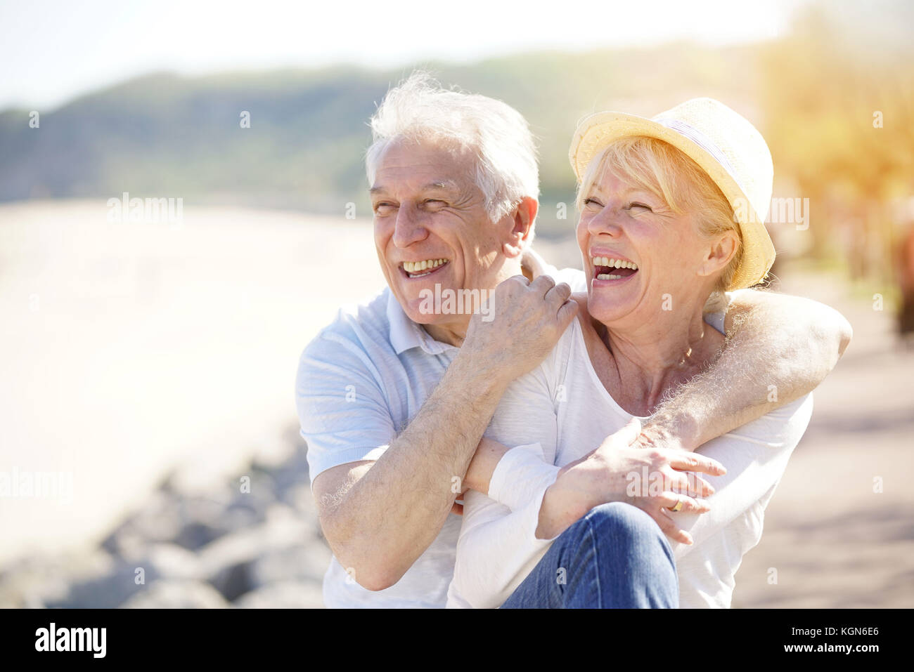 Senior couple relaxing by the sea on sunny day Stock Photo - Alamy