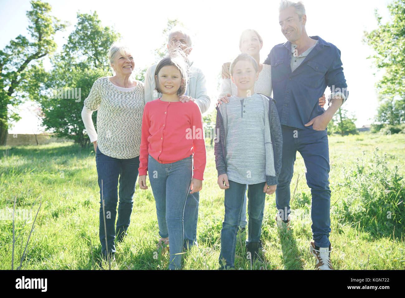 Happy intergenerational family walking in park Stock Photo