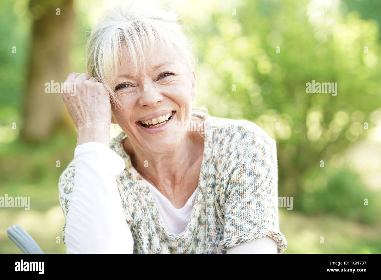Portrait of smiling senior woman relaxing in garden Stock Photo - Alamy