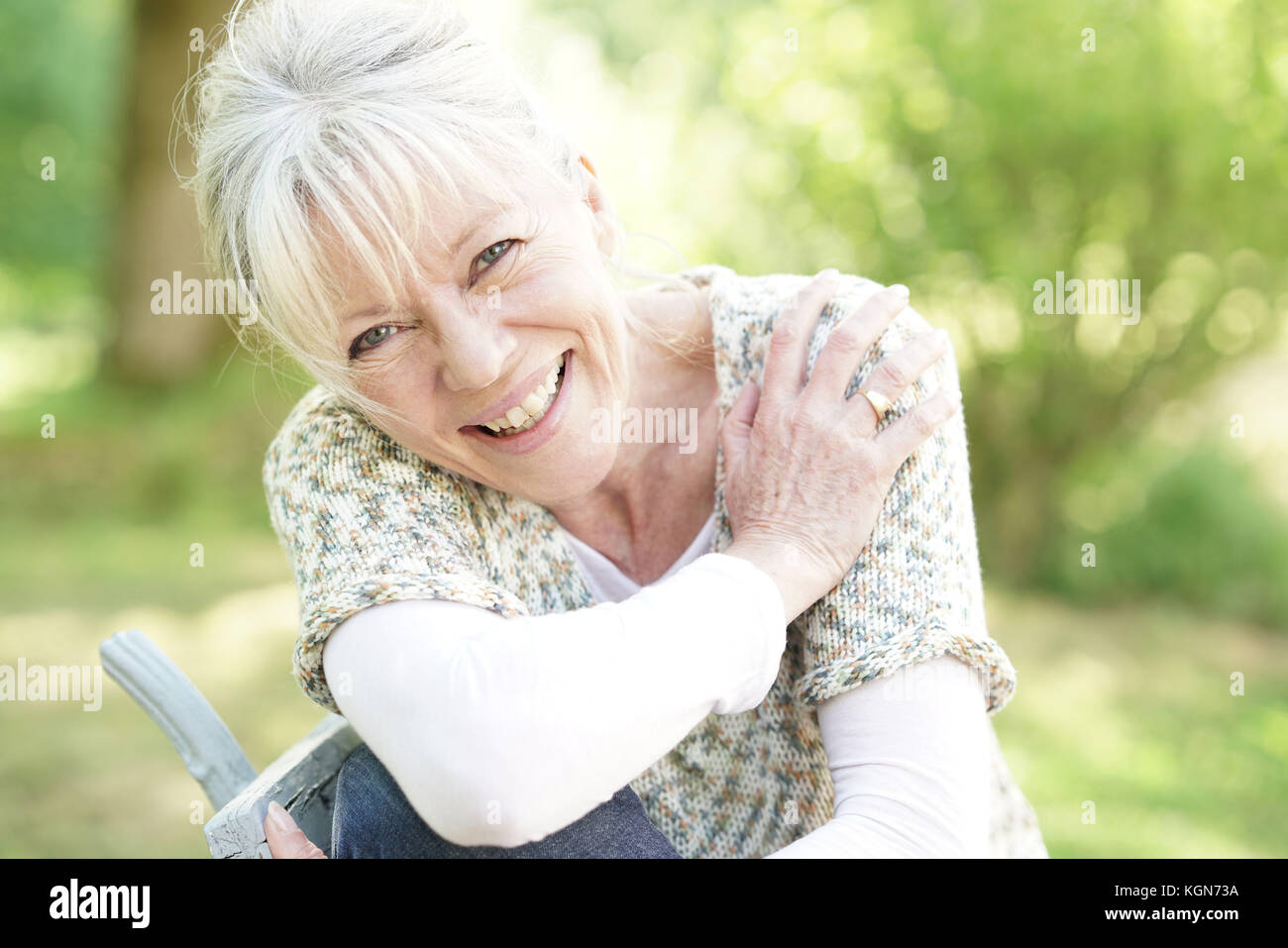 Portrait of smiling senior woman relaxing in garden Stock Photo - Alamy