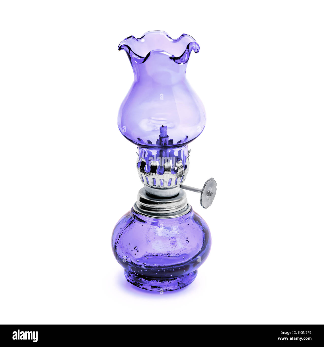 Oil lamp wick lantern made of purple glass and metal isolated on