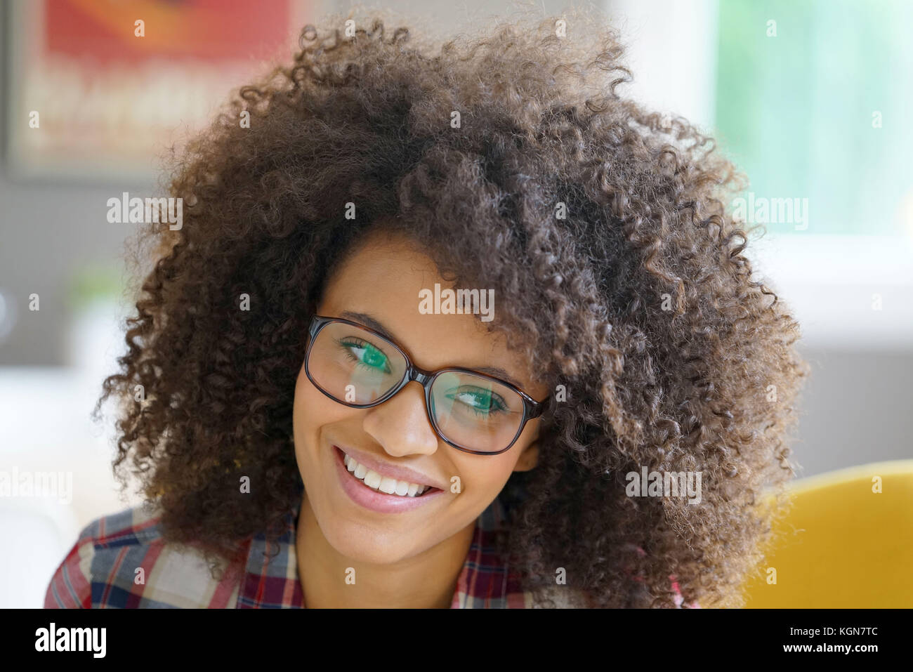 Attractive Mixed Race Woman With Eyeglasses Relaxing In Armchair