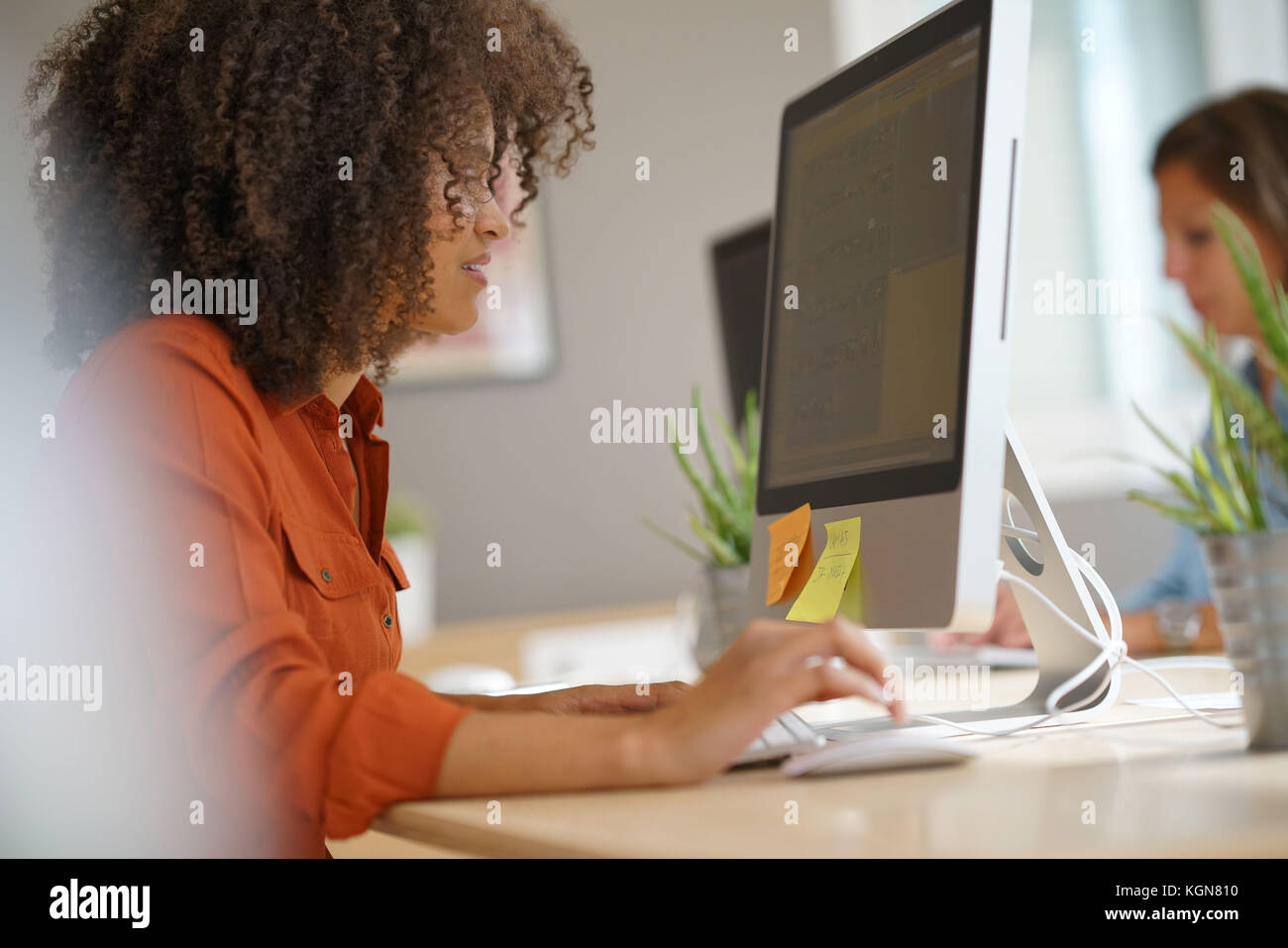 Cheerful businesswoman working on desktop computer Stock Photo - Alamy