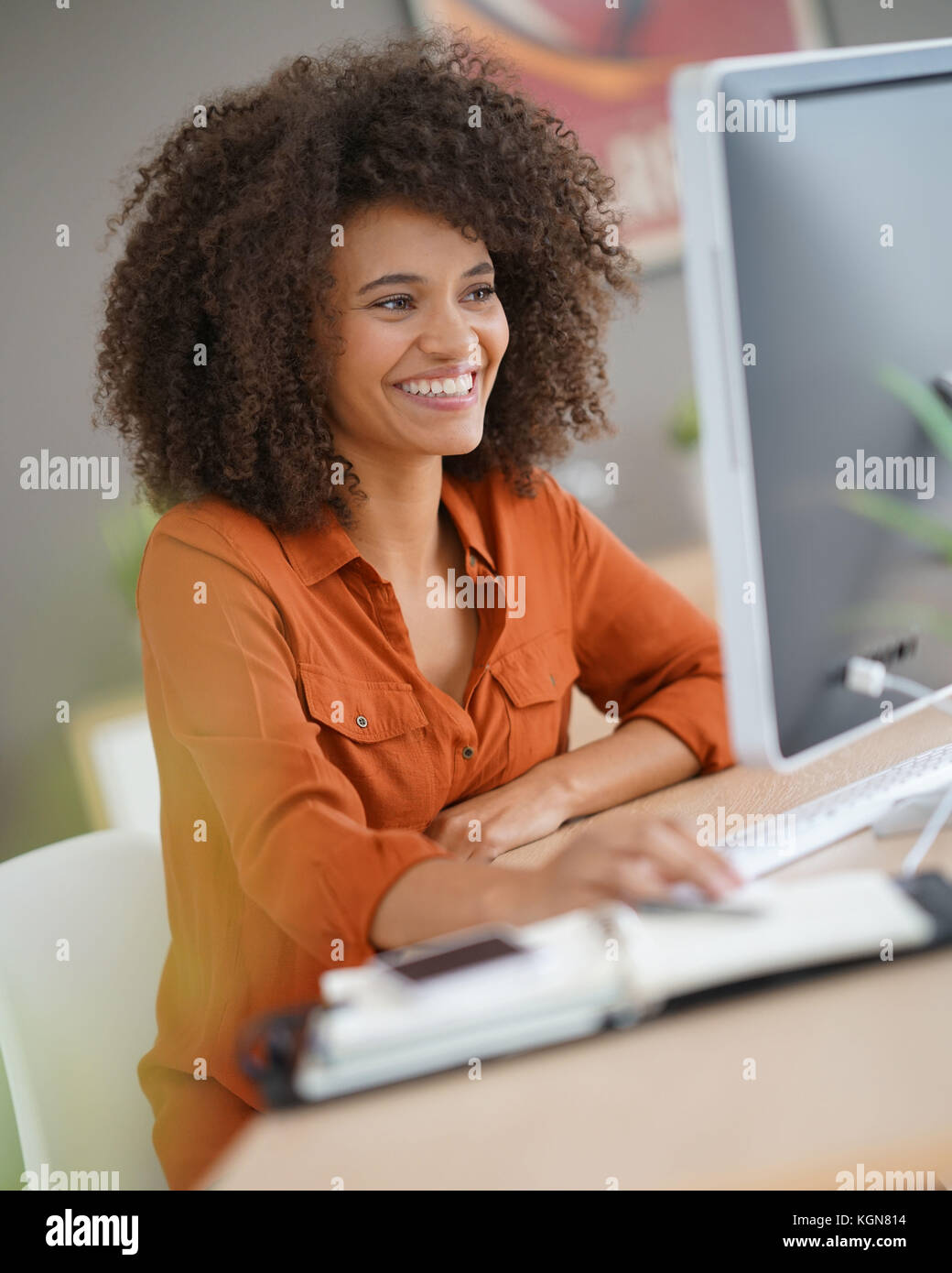 Cheerful businesswoman working on desktop computer Stock Photo - Alamy