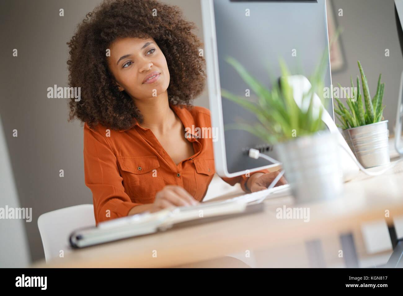Cheerful businesswoman working on desktop computer Stock Photo - Alamy