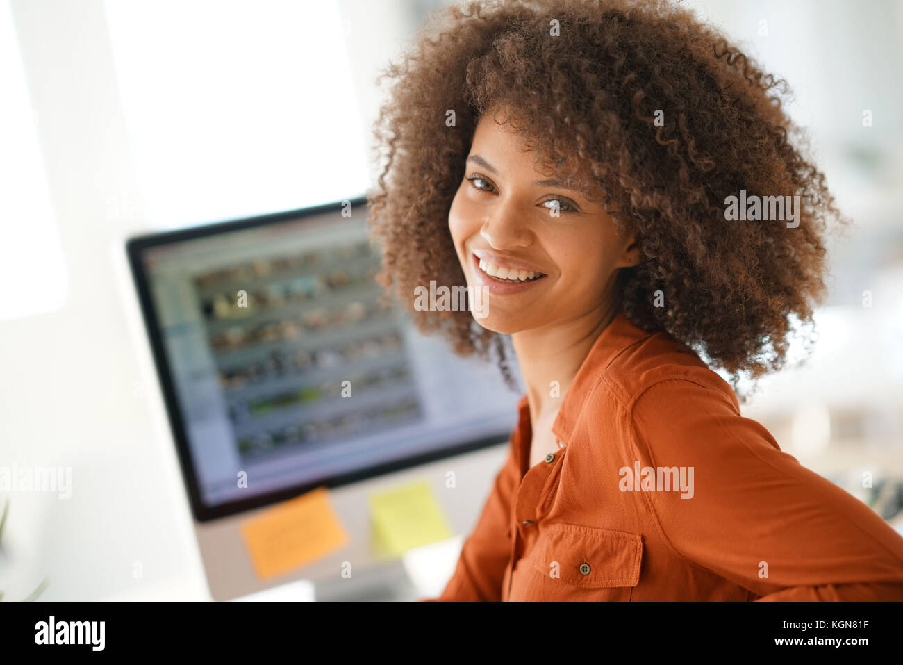 Cheerful businesswoman working on desktop computer Stock Photo - Alamy