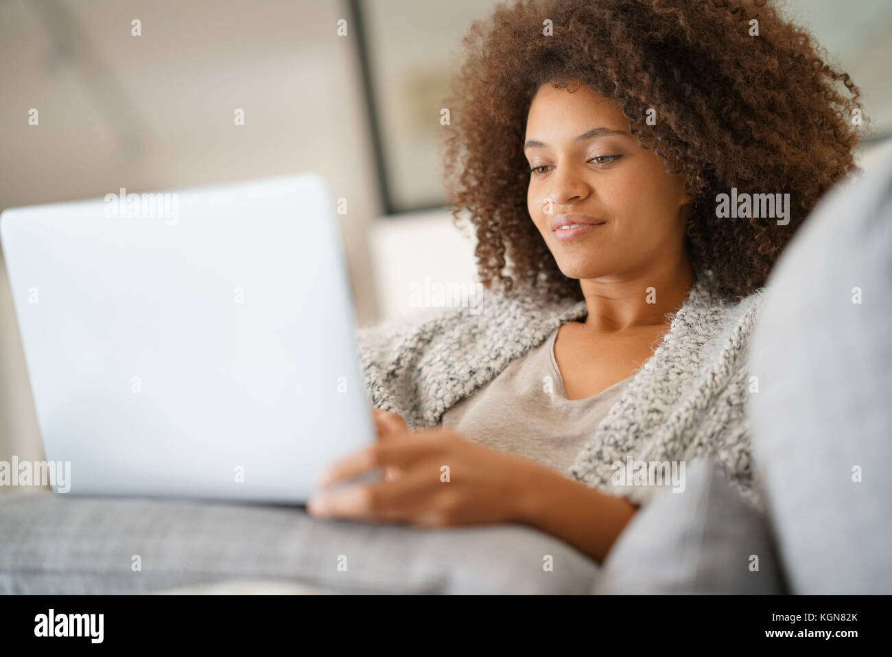 Beautiful woman at home websurfing with laptop computer Stock Photo - Alamy