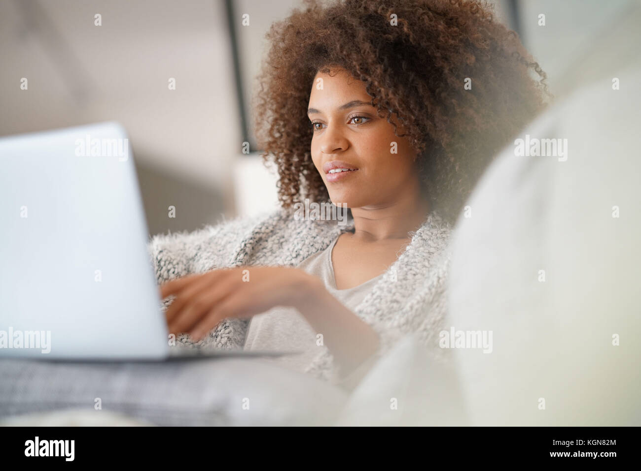 Beautiful woman at home websurfing with laptop computer Stock Photo - Alamy