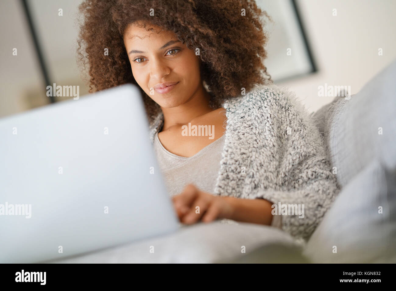 Beautiful woman at home websurfing with laptop computer Stock Photo - Alamy