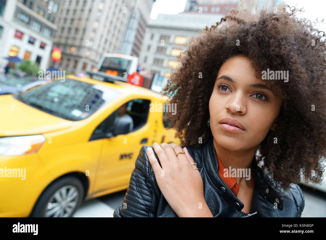 Portrait of mixed-raced girl waiting in street Stock Photo