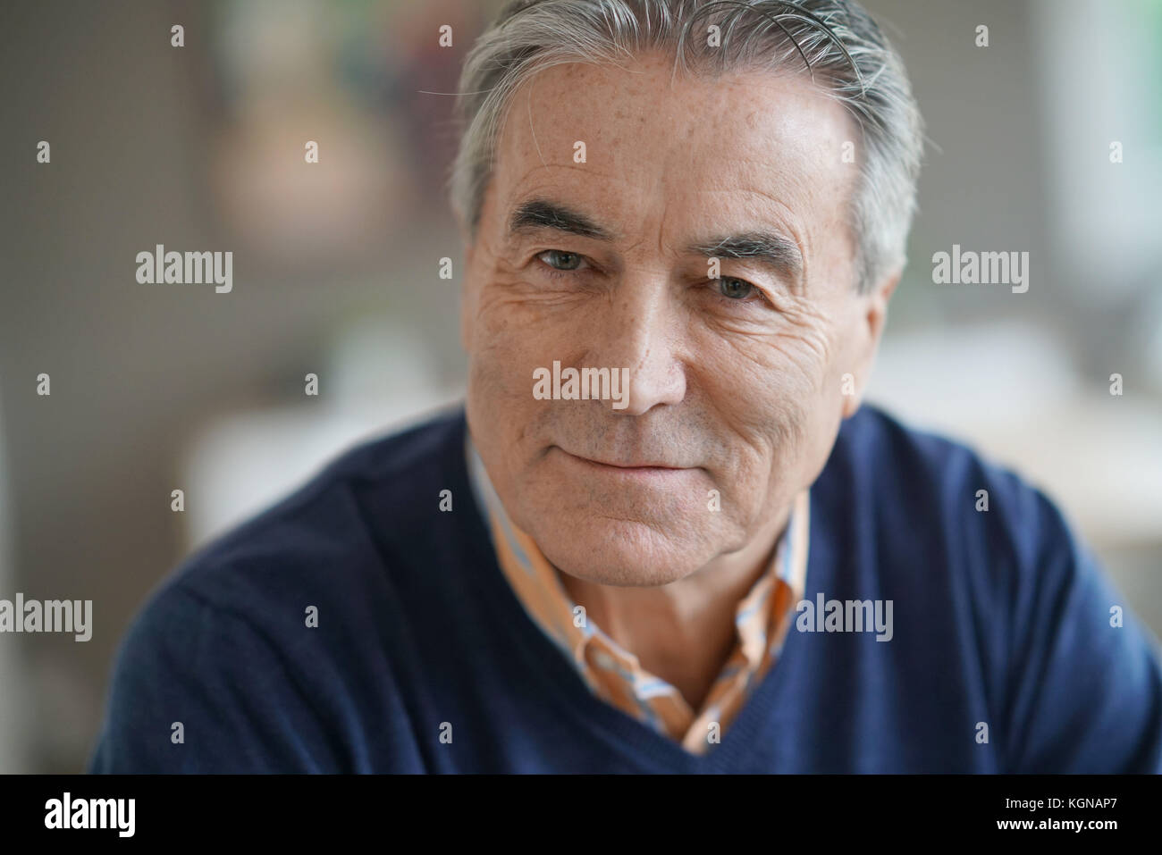 Portrait of senior man with blue sweater looking at camera Stock Photo