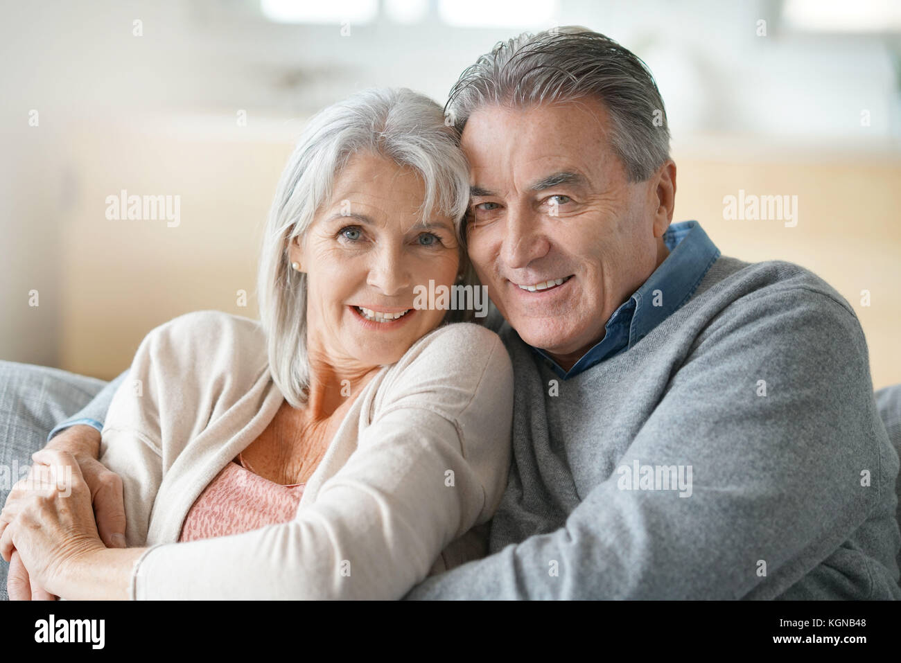 Portrait of senior couple relaxing in sofa Stock Photo - Alamy