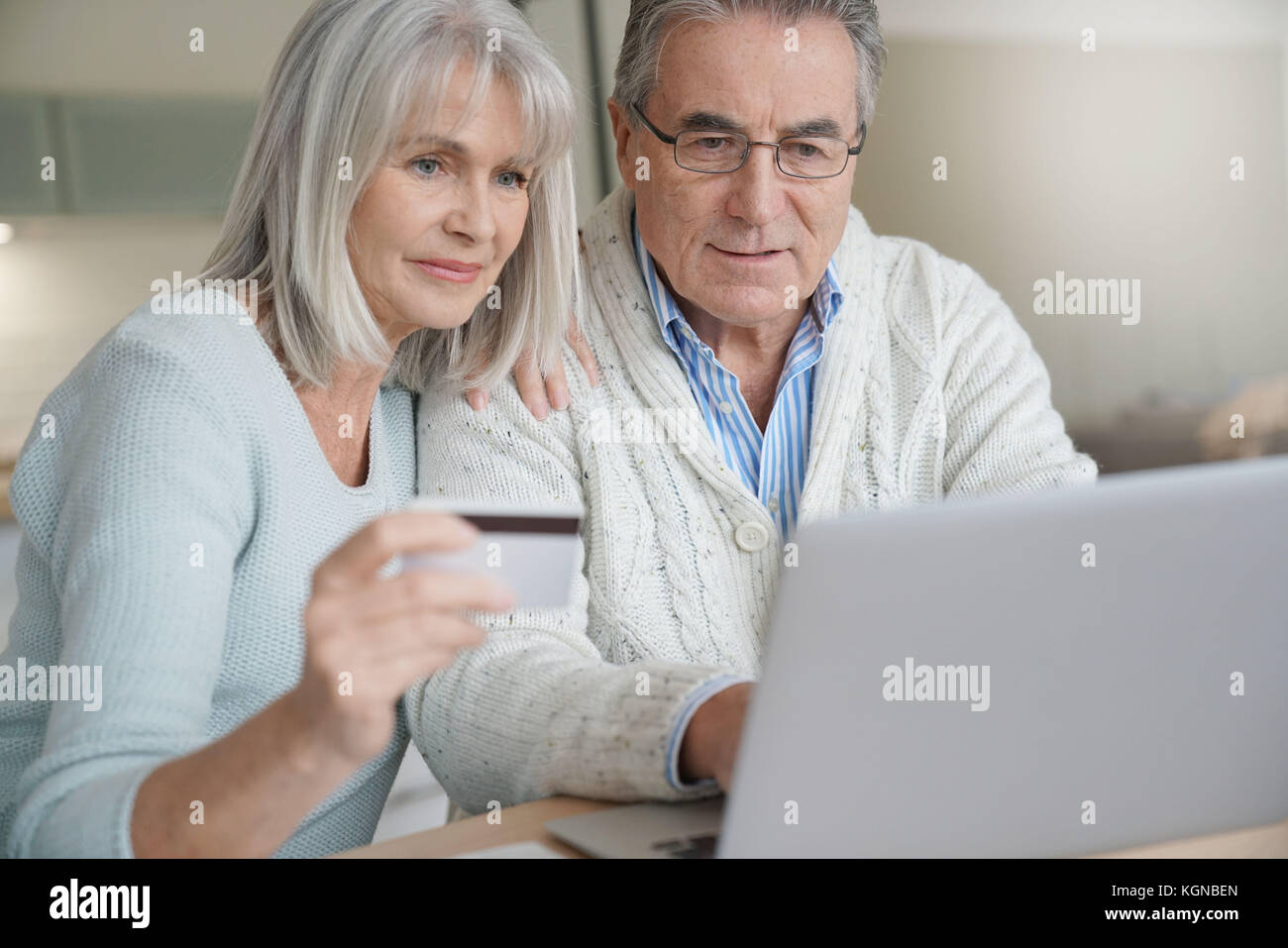 Senior couple buying on internet with credit card Stock Photo