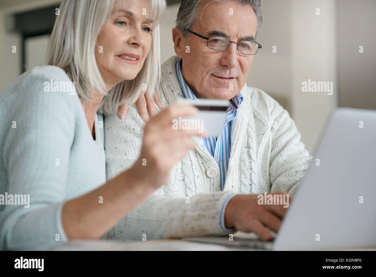 Senior couple buying on internet with credit card Stock Photo