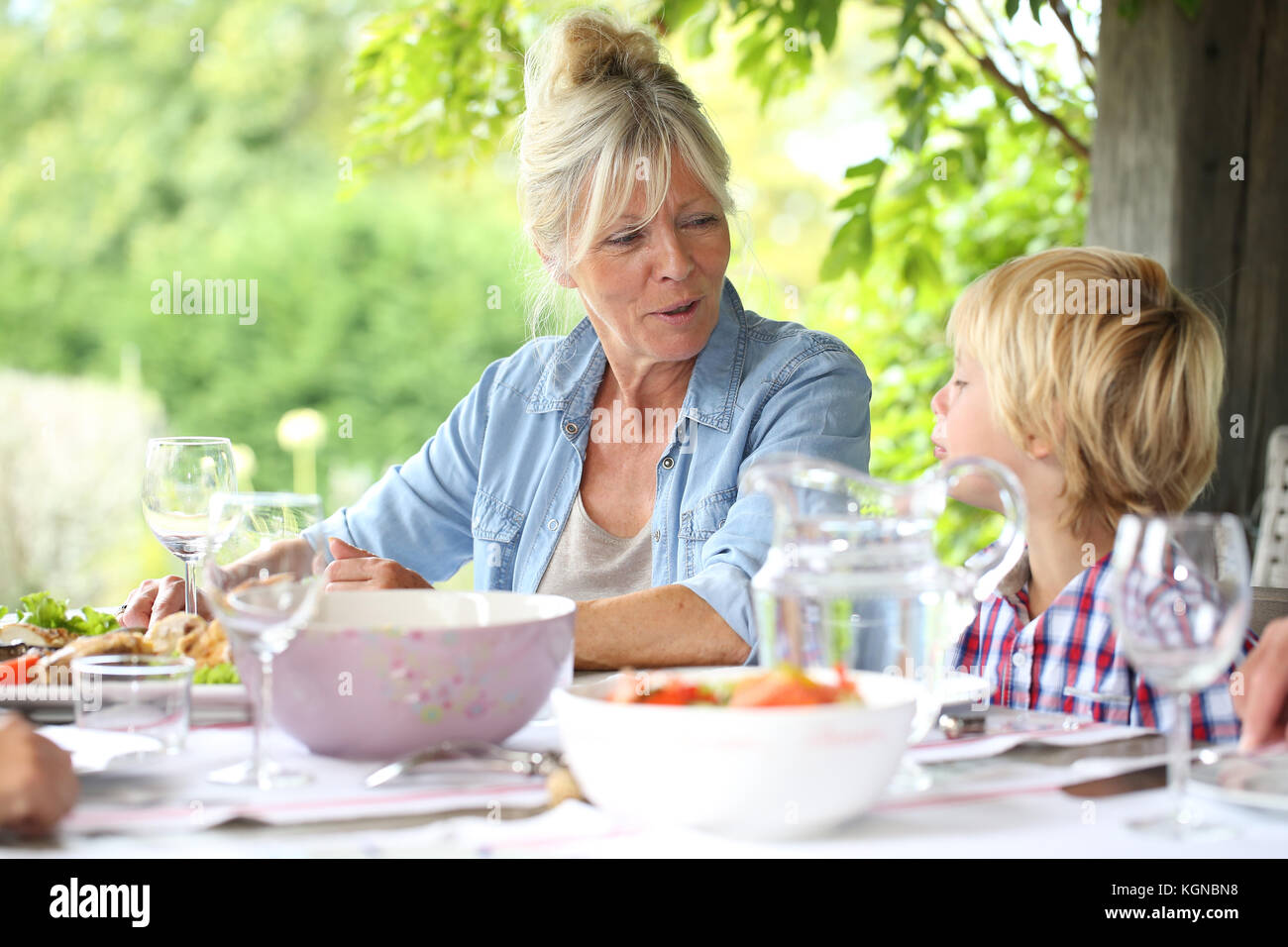 Portrait of grandmother with kid having lunch Stock Photo