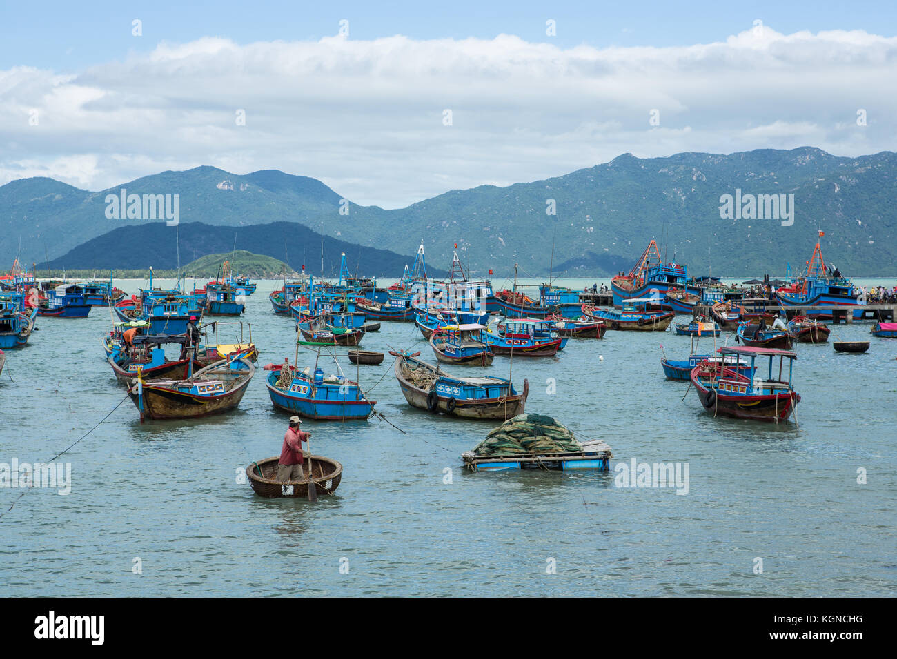 Traditional old wooden Vietnamese boats and round fishing boats Thung Chai. Local woven bamboo basket boats or coracle moored near harbour. Vietnam Stock Photo