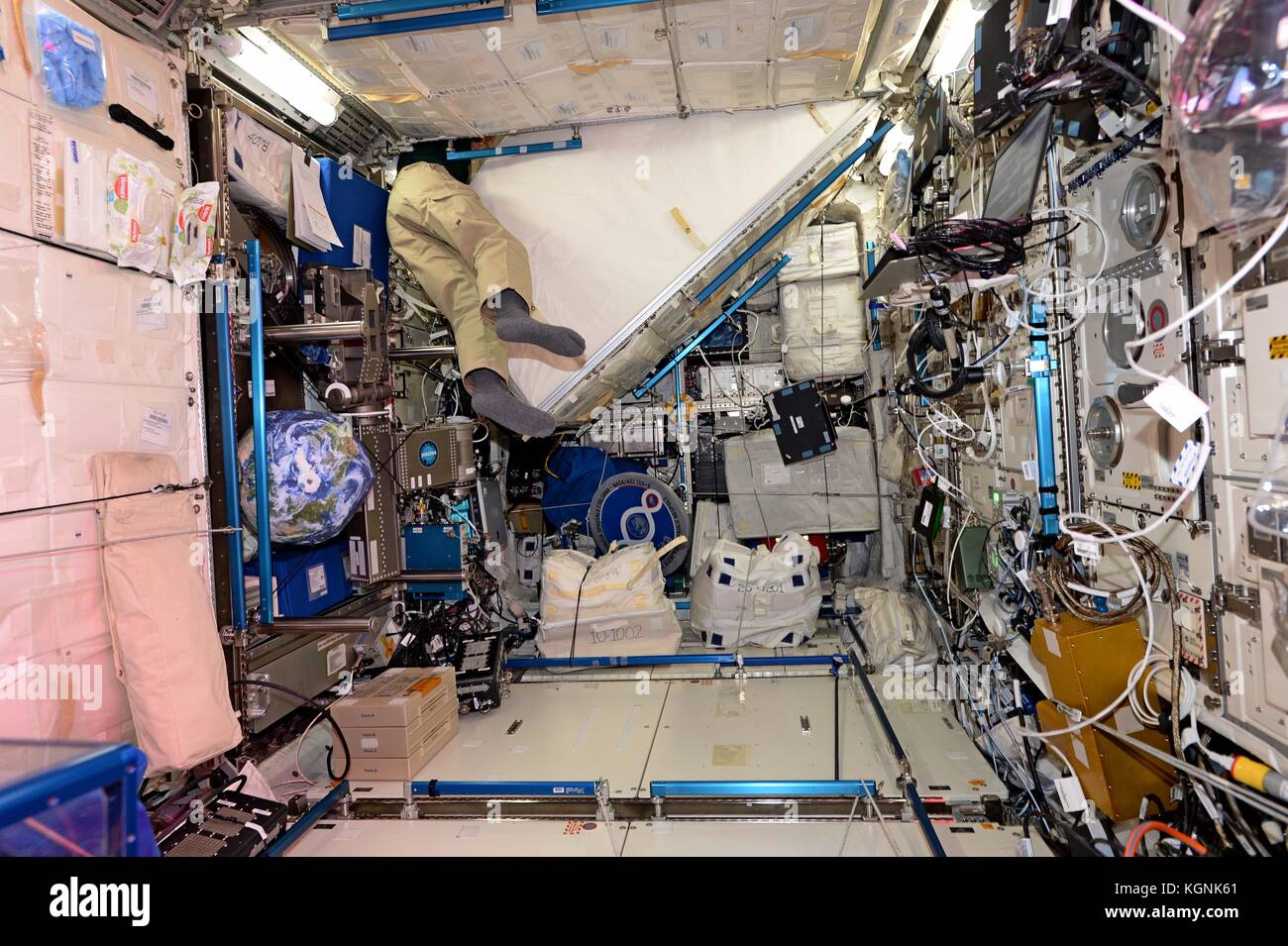 International Space Station, Earth Orbit. 09th Nov, 2017. The legs of Expedition 53 American astronaut Randy Bresnik stick out as he maneuvers around racks of gear that line the International Space Station for storage November 9, 2017 in Earth Orbit. Credit: Planetpix/Alamy Live News Stock Photo