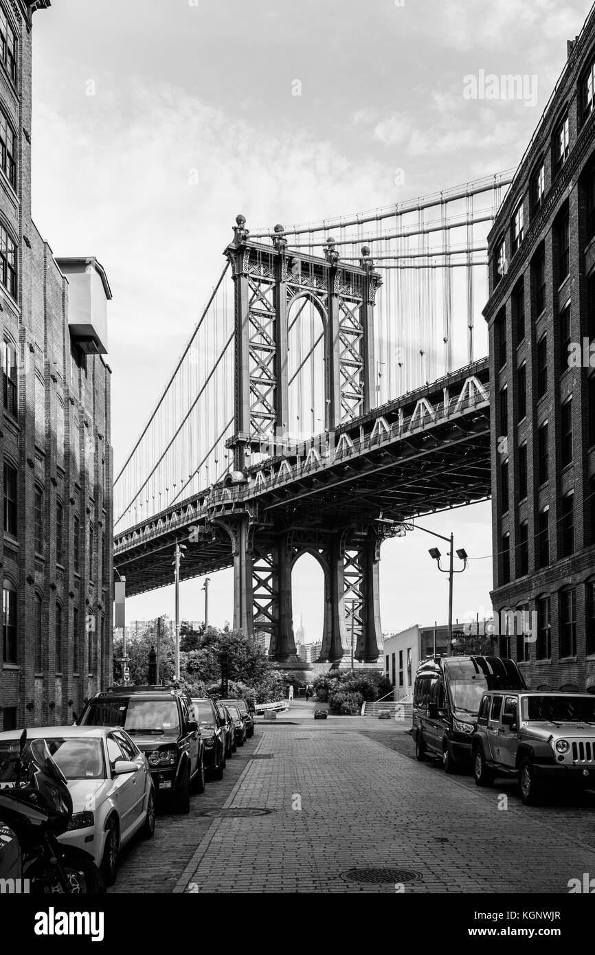 Manhattan Bridge against sky seen from street in city, New York City, New York, USA Stock Photo