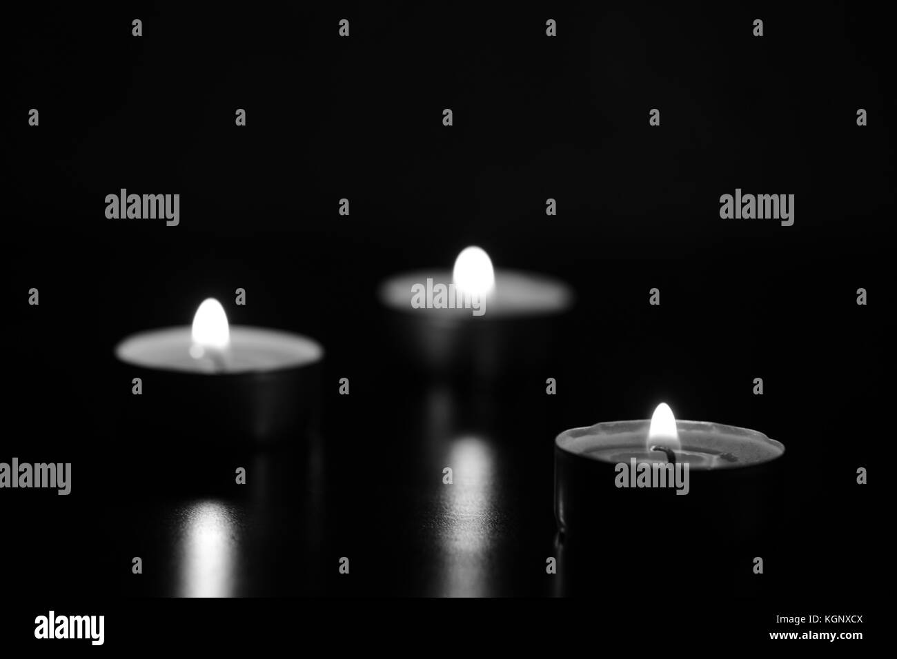 Burning candles in the dark. Black and white Stock Photo Alamy