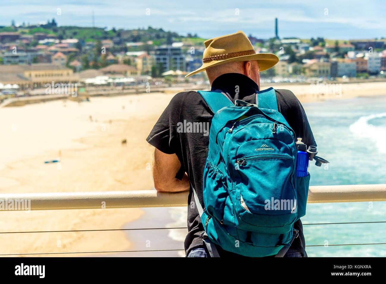 A local watches the waves roll into the famous Bondi Beach in Sydney, NSW, Australia Stock Photo