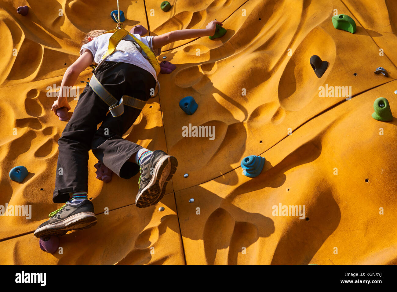Child climbing a rock wall outdoor - bouldering Stock Photo - Alamy