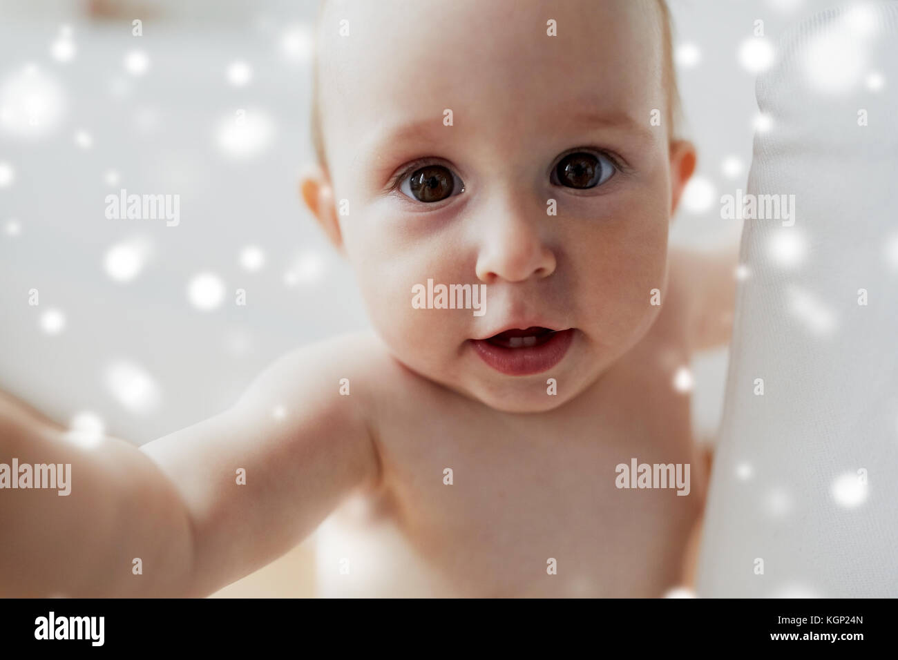close up of happy little baby over snow Stock Photo
