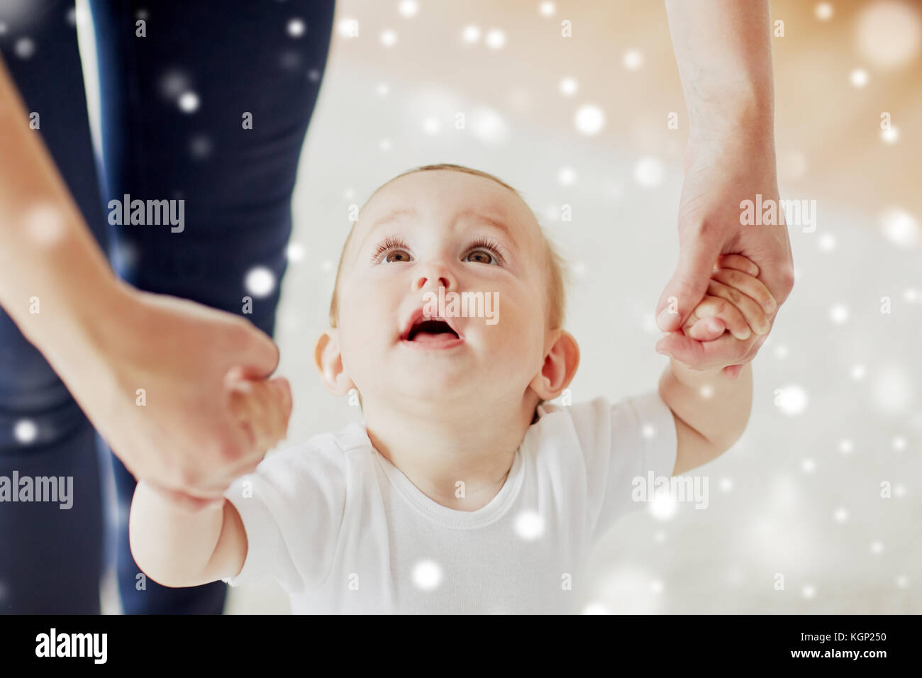 happy baby learning to walk with mother help Stock Photo