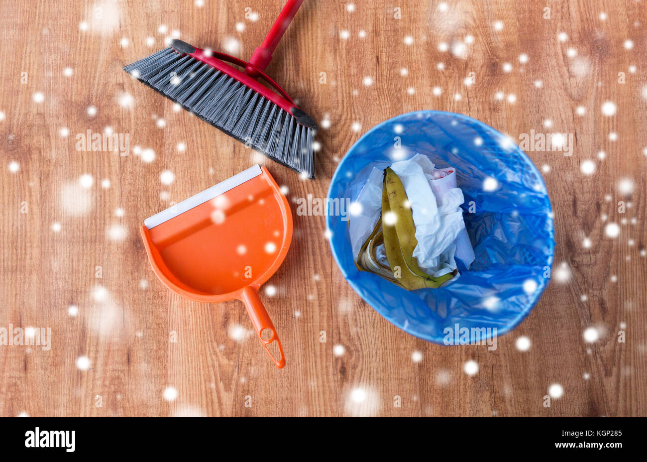 rubbish bin with trash, swab and dustpan on floor Stock Photo