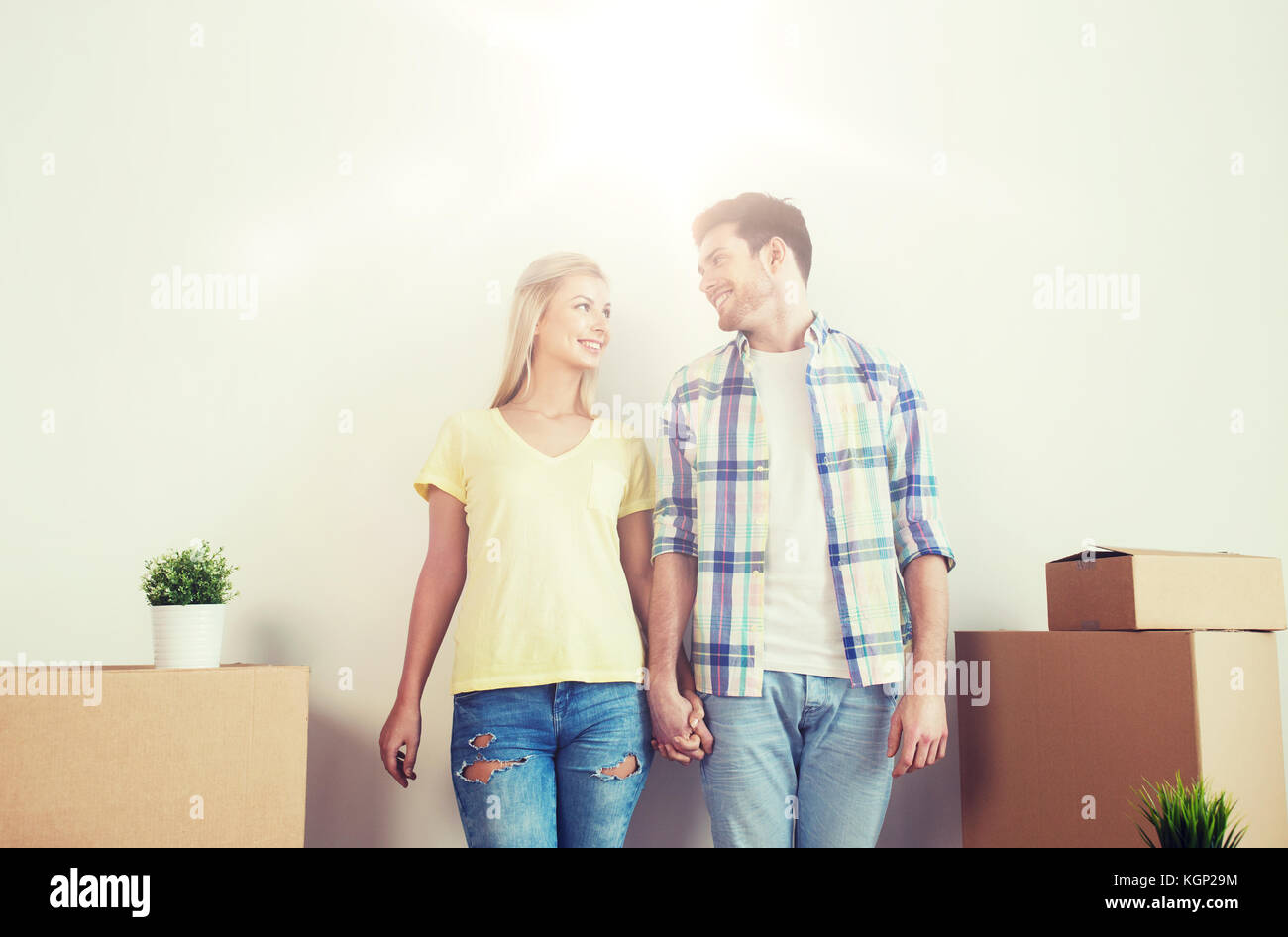 smiling couple with big boxes moving to new home Stock Photo - Alamy