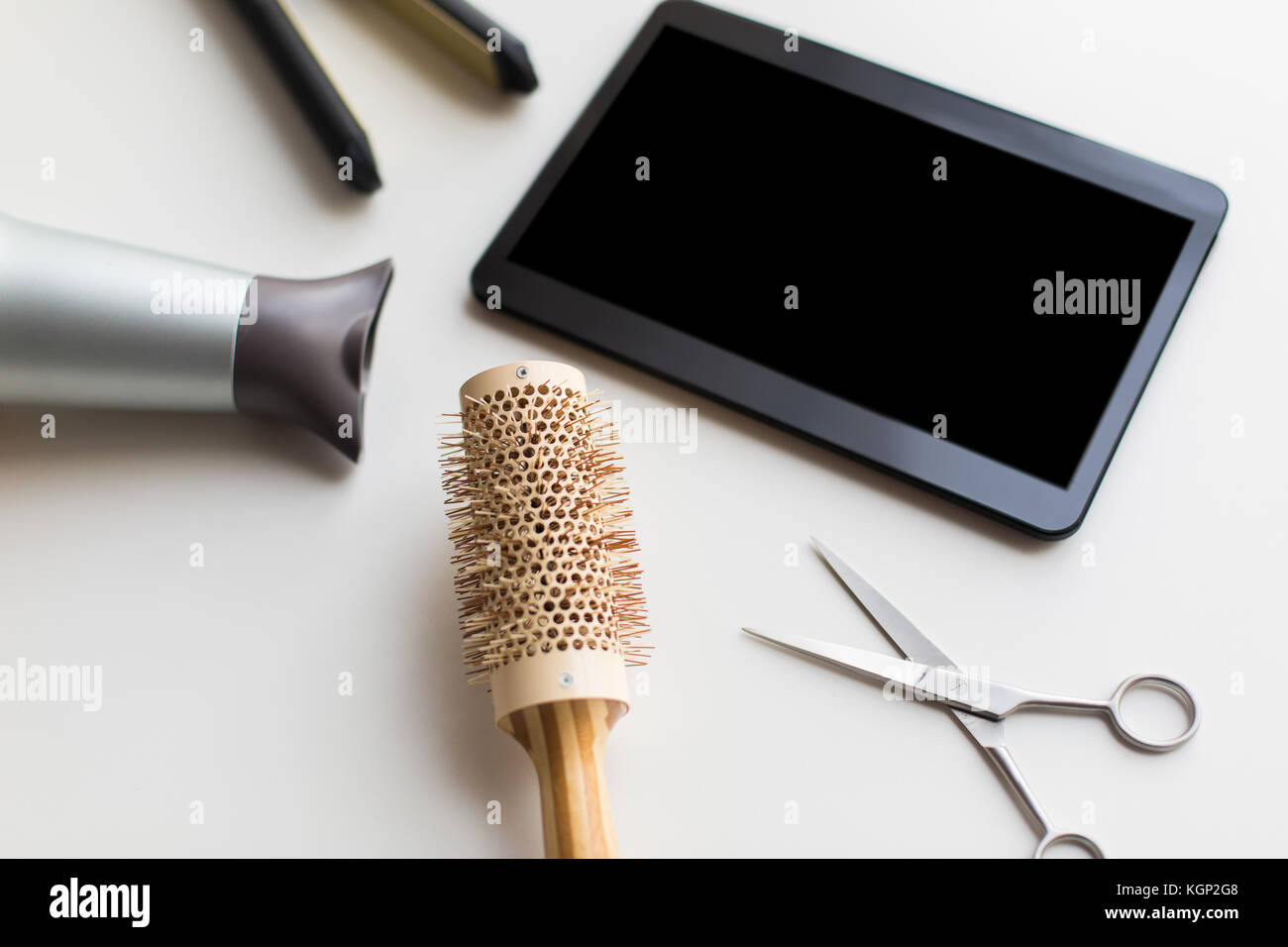 tablet pc, scissors, hairdryer, hot iron and brush Stock Photo Alamy