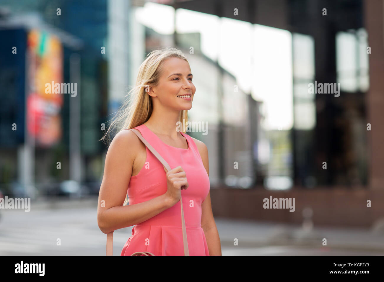 happy smiling young woman on city street Stock Photo - Alamy