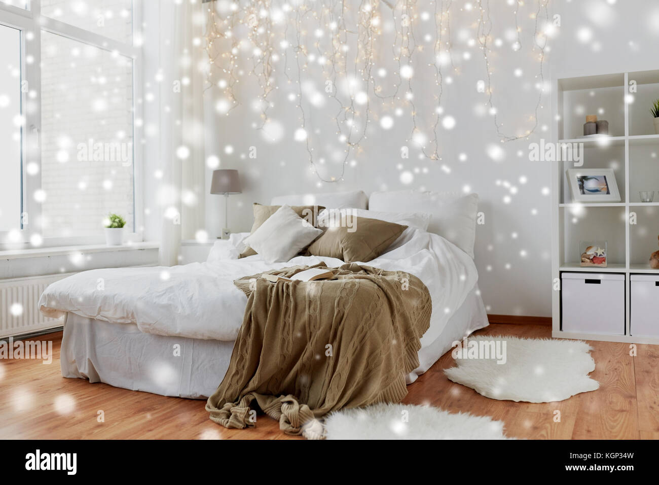 bedroom with bed and christmas garland at home Stock Photo