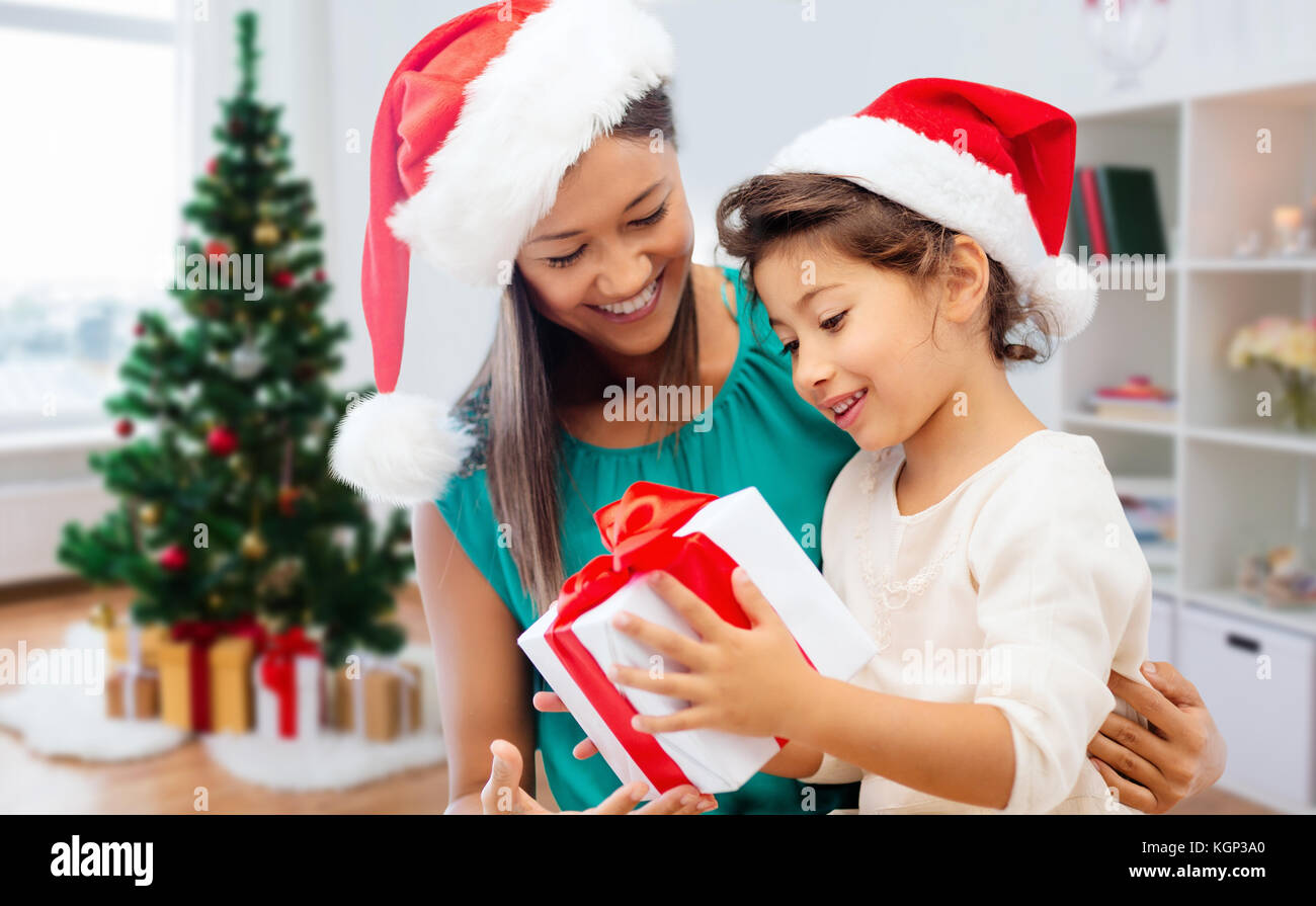 happy mother and daughter with christmas gift Stock Photo - Alamy